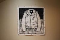 a black and white drawing of a jacket hanging on a wall