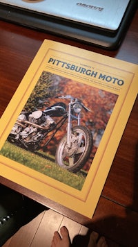 a picture of a motorcycle on a table next to a laptop